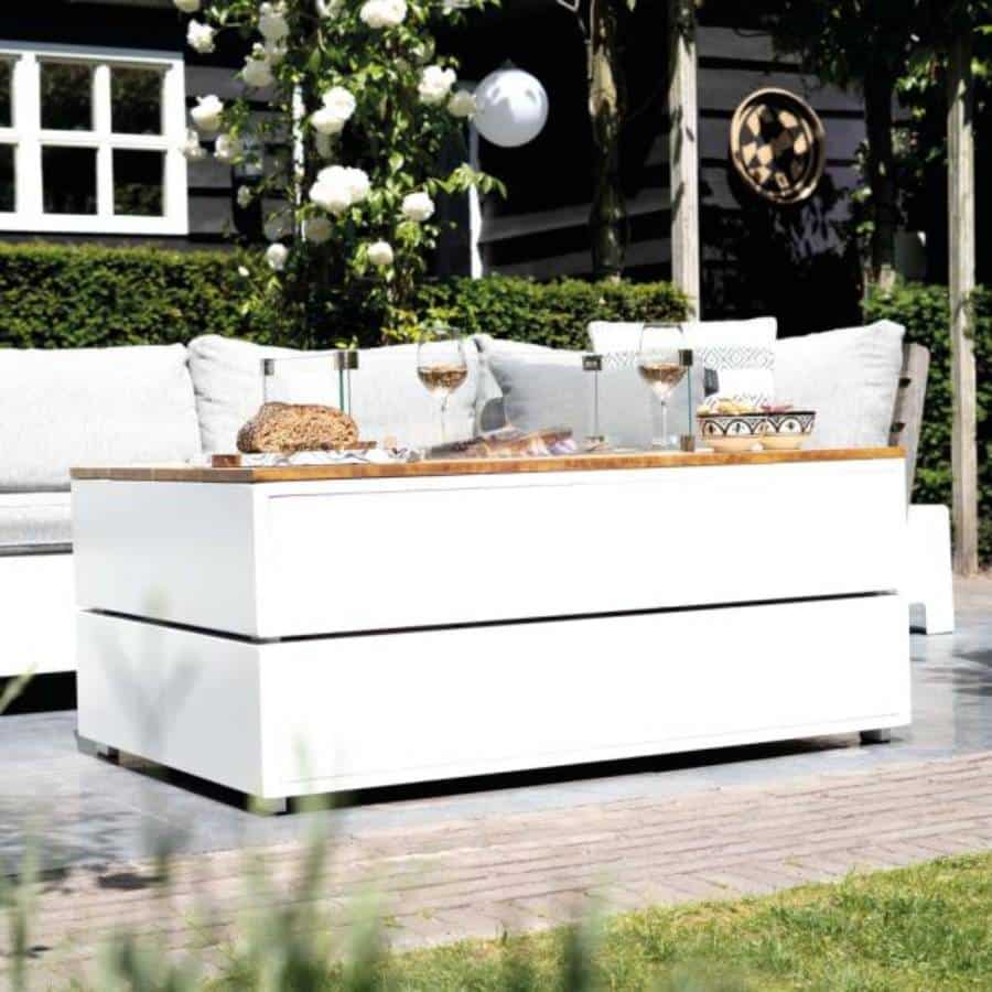 COSIPURE 120 on a beautiful terrace with lots of green and a white sofa