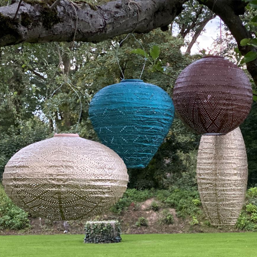 Balloon Solar Lantern MANDELA Blue - Lumix ambient photo several lanterns of different colors hanging from the branch of a tree x behind you can see a large garden