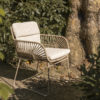 MURCIA garden chair by 4 Seasons Outdoor®, oblique view in a garden in front of the trunk of a large tree
