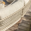 The Sardinia garden sofa by 4SO is a curved sofa with a chaise longue, seating 4. Its curved stainless steel frame is finished in a beautiful tan beige, a rich, toasted shade of café au lait. Rope in the same tones creates a triangular pattern that allows for airflow and adds a touch of sophistication. The generous cushions ensure exceptional comfort. Detail of the backrest.