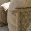 The Sardinia garden sofa by 4SO is a curved sofa with a chaise longue, seating 4. Its curved stainless steel frame is finished in a beautiful tan beige, a rich, toasted shade of café au lait. Rope in the same tones creates a triangular pattern that allows for airflow and adds a touch of sophistication. The generous cushions ensure exceptional comfort. Detail of the armrest.