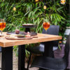 Mesa bar Yasmani 100 de Hartman Con patas de aluminio en antracita y tablero de teca. Una mesa de diseño moderno y robusto, que le aporta estabilidad a esta mesa de bar para jardín.