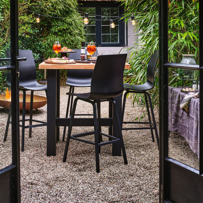 Mesa bar Yasmani 100 de Hartman Con patas de aluminio en antracita y tablero de teca. Una mesa de diseño moderno y robusto, que le aporta estabilidad a esta mesa de bar para jardín.