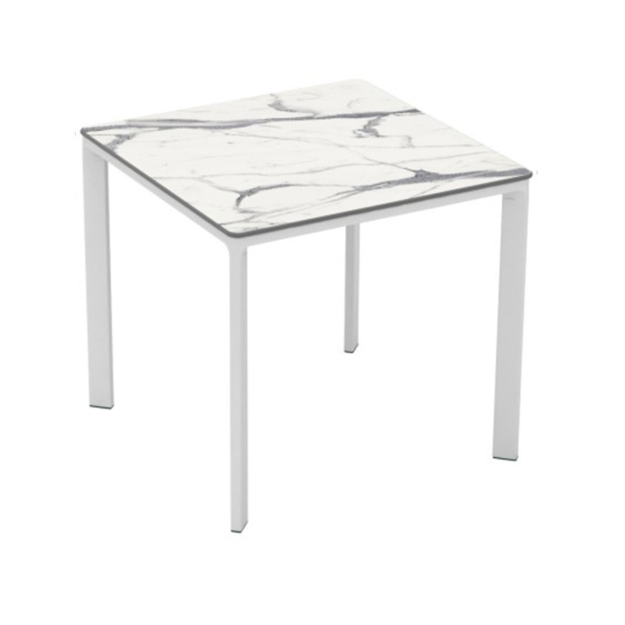 Meet Table by Ezpeleta 80x80cm With a white aluminium structure and a white marble HPL top. Suitable for indoor and outdoor use, both for public and residential settings. Find it at De Tropen, your outdoor furniture expert. Oblique front view