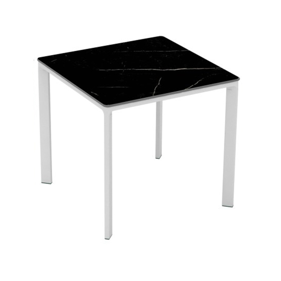 Meet Table by Ezpeleta 80x80cm With a white aluminium structure and a black marble HPL top. Suitable for indoor and outdoor use, both for public and residential settings. Find it at De Tropen, your outdoor furniture expert. Oblique front view