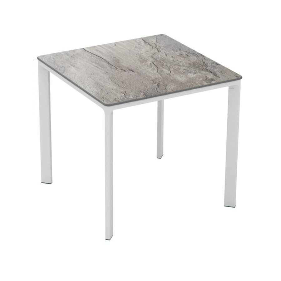 Meet Table by Ezpeleta 80x80cm With a white aluminium structure and a stone HPL top. Suitable for indoor and outdoor use, both for public and residential settings. Find it at De Tropen, your outdoor furniture expert. Oblique front view