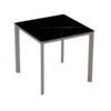 Meet Table by Ezpeleta 80x80cm With a taupe aluminium structure and a black marble HPL top. Suitable for indoor and outdoor use, both for public and residential settings. Find it at De Tropen, your outdoor furniture expert. Oblique front view