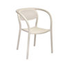 The Noon armchair in pearl, an off-white or bone-like finish, is from the Valencian brand Ezpeleta. The matte finish makes this armchair even more sophisticated. Made of fiberglass-reinforced polypropylene, it's a very comfortable chair, especially thanks to the curved backrest that cradles and supports the back. The same line runs through the front legs, armrests, and backrest, seamlessly blending into the rest of the structure, as it's a single, monoblock piece. The backrest mimics the weave of classic rattan, forming circles that allow air to circulate. It features non-slip feet and UV protection. It's 100% recyclable and suitable for both indoor and outdoor use. Ideal for residential and public spaces. Find it at De Tropen, your outdoor furniture expert. Oblique front view.