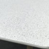 Talara Dining Table by Gardenline. Detail of the edge of the rectangular table with a terrazzo top and acacia legs. Buy it at De Tropen, your expert in garden and patio furniture.