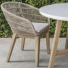 Talara dining chair by Gardenline. The chair is seen next to the round table. Buy it at De Tropen, your expert in garden and patio furniture.